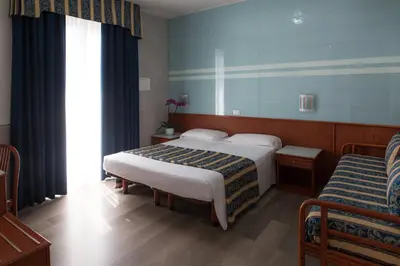 Letto o letti in una camera di Hotel Colombo