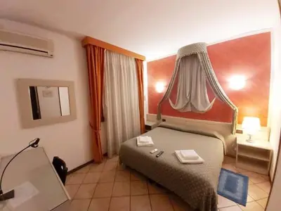 Letto o letti in una camera di Hotel Arcella