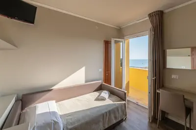 Letto o letti in una camera di Hotel Mondial
