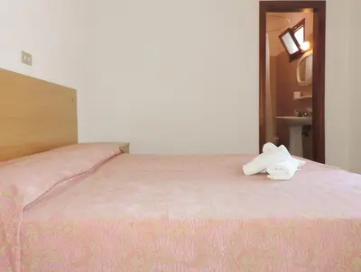 Letto o letti in una camera di Hotel Saturno
