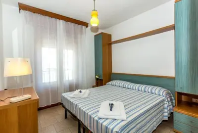 Letto o letti in una camera di Hotel Saturno