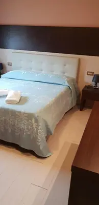 Letto o letti in una camera di Hotel Colombo