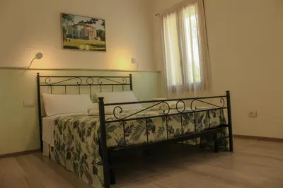 Letto o letti in una camera di B&B L'arte è di casa