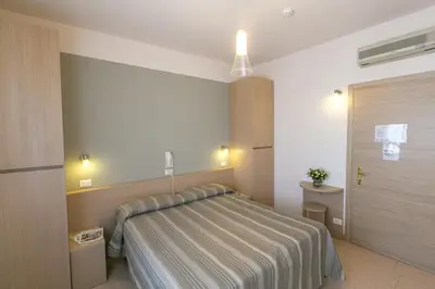 Letto o letti in una camera di Hotel Colonna