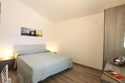 Letto o letti in una camera di Villaggio Olmè