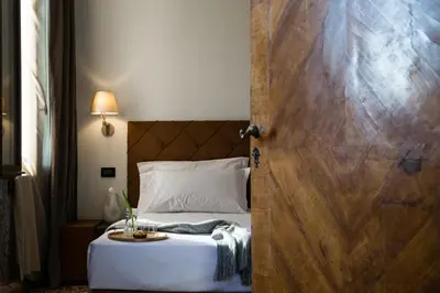 Letto o letti in una camera di Riva del Vin BOUTIQUE HOTEL