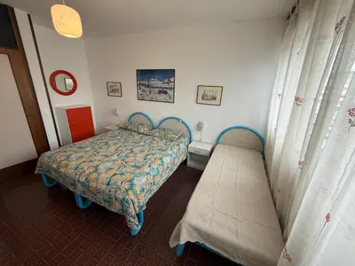 Letto o letti in una camera di RESIDENCE MARINA MARCONI - WALTERIGATO Apartments SOLO PER FAMIGLIE