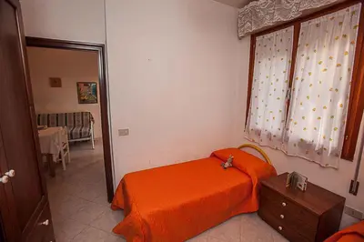 Letto o letti in una camera di Apartments in Rosolina Mare 25071