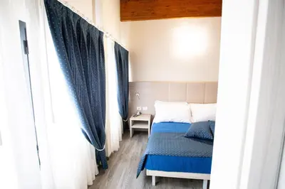 Letto o letti in una camera di HOME HOTEL