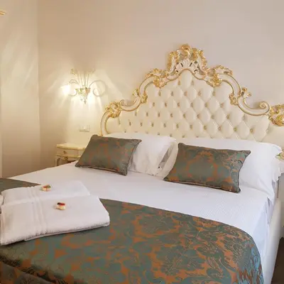 Letto o letti in una camera di Ca' Vittoria Boutique House ApartSuite Chioggia