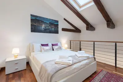 Letto o letti in una camera di Ca' del Pozzo Loft Apartment