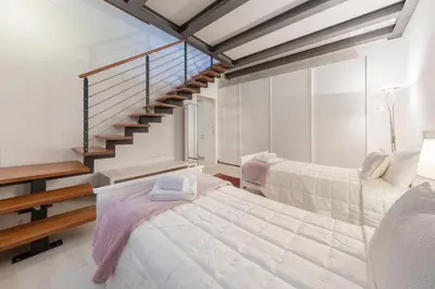 Letto o letti in una camera di Ca' del Pozzo Loft Apartment