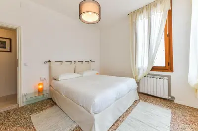 Letto o letti in una camera di Fortuny Loft