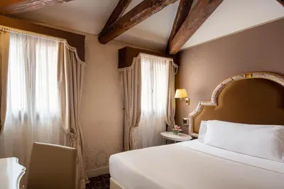 Letto o letti in una camera di Residenza Venezia | UNA Esperienze