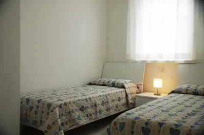 Letto o letti in una camera di Cala Blu Residence con piscina-Centralissimo Lido di Jesolo