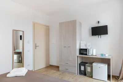 Letto o letti in una camera di San Vincenzo Rooms Vigonza