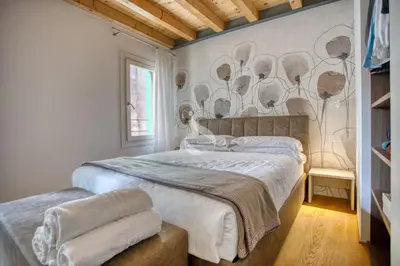 Letto o letti in una camera di Ca' dei Battuti Apartments