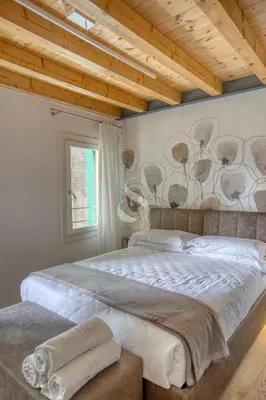 Letto o letti in una camera di Ca' dei Battuti Apartments