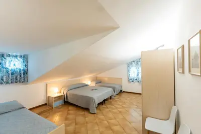 Letto o letti in una camera di Quadrilocale e Mansarde Bafile241 - Adria Holiday Jesolo - FAMILY APARTMENTS