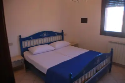 Letto o letti in una camera di Acquasmeralda appartamento 01
