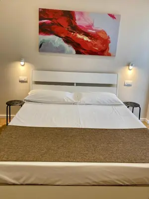 Letto o letti in una camera di Maison Altinia, locazione in centro storico a due passi dalla stazione