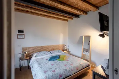 Letto o letti in una camera di BACARìA DA DANTE Rooms