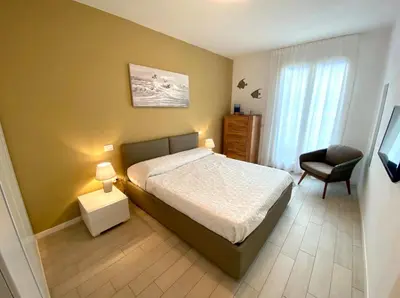 Letto o letti in una camera di Appartamenti Wave Village 2 - Carraro Immobiliare - Family Apartments