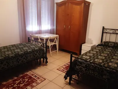 Letto o letti in una camera di Locazione Menini - Appartamento zona stazione