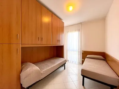 Letto o letti in una camera di Residence Ca D'Oro con piscina Cavallino - Carraro Immobilare - Family Apartments