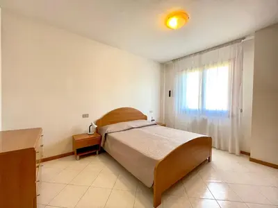 Letto o letti in una camera di Residence Ca D'Oro con piscina Cavallino - Carraro Immobilare - Family Apartments