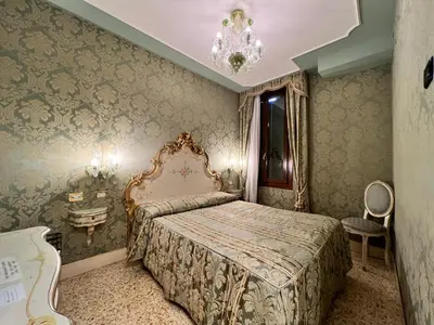 Letto o letti in una camera di Hotel Ca' Dogaressa