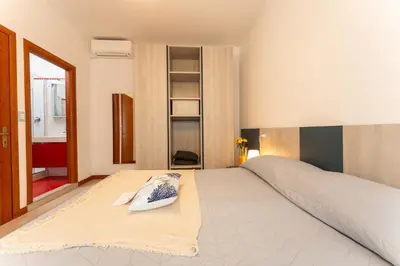 Letto o letti in una camera di Appartamenti Casa De Lazzari - Piazza Brescia - Adria Holiday Jesolo - FAMILY APARTMENTS