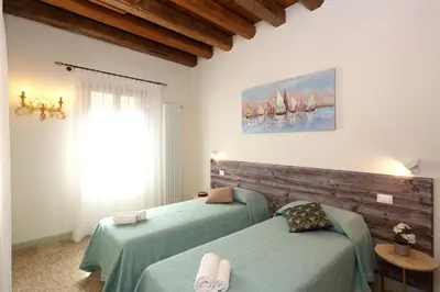 Letto o letti in una camera di Ca' del Pittor Apartments