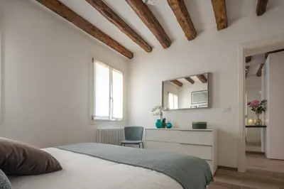 Letto o letti in una camera di San Giacomo dall'Orio Garden Apartment R&R