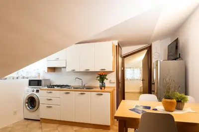 Cucina o angolo cottura di Mansarda 7 Trilocale, Bafile241 - 2' Piano NO Ascensore - Adria Holiday Jesolo - FAMILY APARTMENT