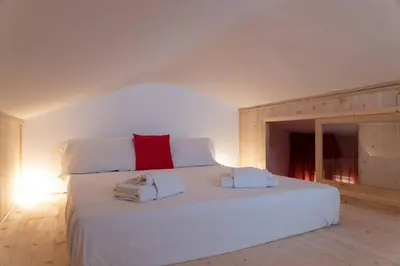 Letto o letti in una camera di enJoy Home - Mansarda Piccolo Tesoro in centro città