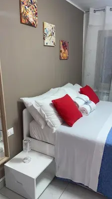 Letto o letti in una camera di LAGUNA BLU Camera TRAMONTO con terrazza panoramica in comune