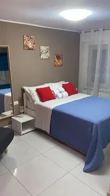 Letto o letti in una camera di LAGUNA BLU Camera TRAMONTO con terrazza panoramica in comune
