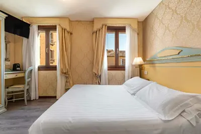 Letto o letti in una camera di Hotel Falier