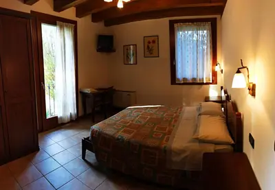 Letto o letti in una camera di Agriturismo L'Albara - Wines, Pool & SPA