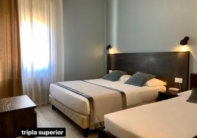 Letto o letti in una camera di Hotel Ariston
