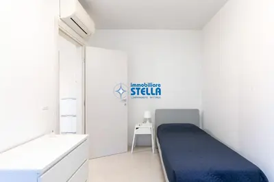 Letto o letti in una camera di Condominio Diamante