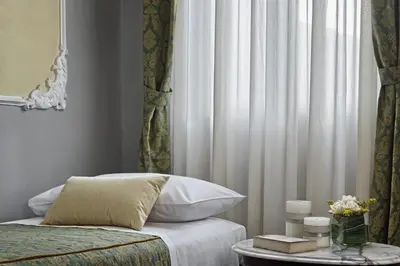 Letto o letti in una camera di Hotel Pausania