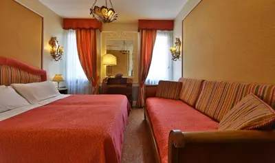 Letto o letti in una camera di Hotel Arlecchino