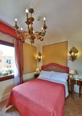 Letto o letti in una camera di Hotel Arlecchino