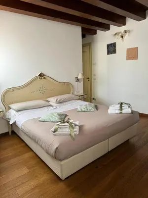 Letto o letti in una camera di Alloggi Ai Tessitori