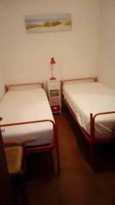 Letto o letti in una camera di Condominio Mara- SOLO PER FAMIGLIE- Walterigato Apartments