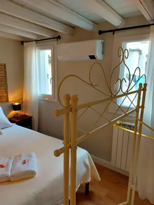 Letto o letti in una camera di Canal Vena ApartSuite House Chioggia