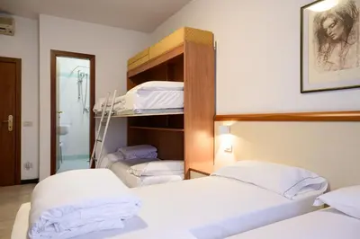 Letto o letti in una camera di HG Hotel Due Ragni