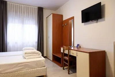 Letto o letti in una camera di HG Hotel Due Ragni